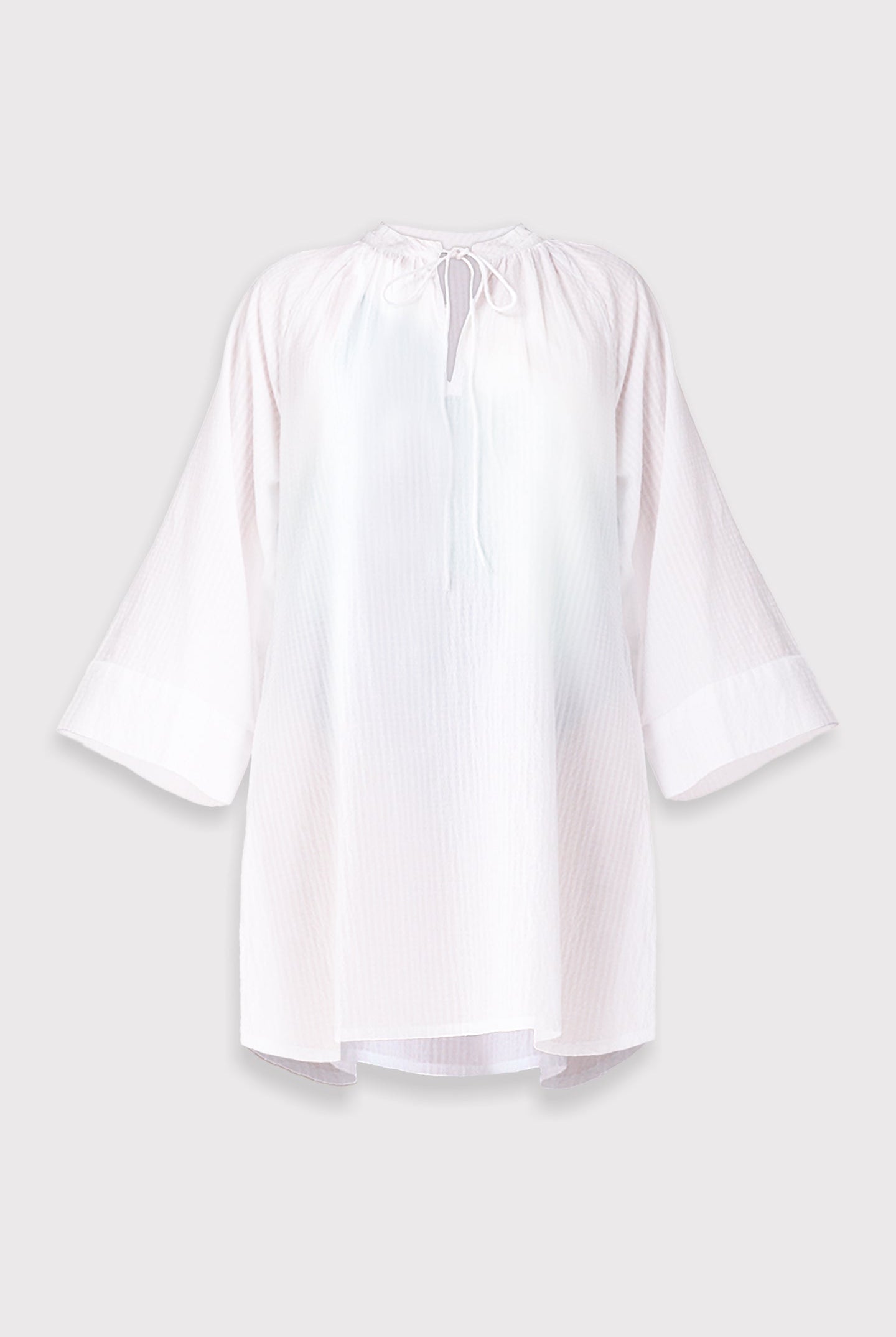 White beach cover-up with bell sleeves on a light gray background