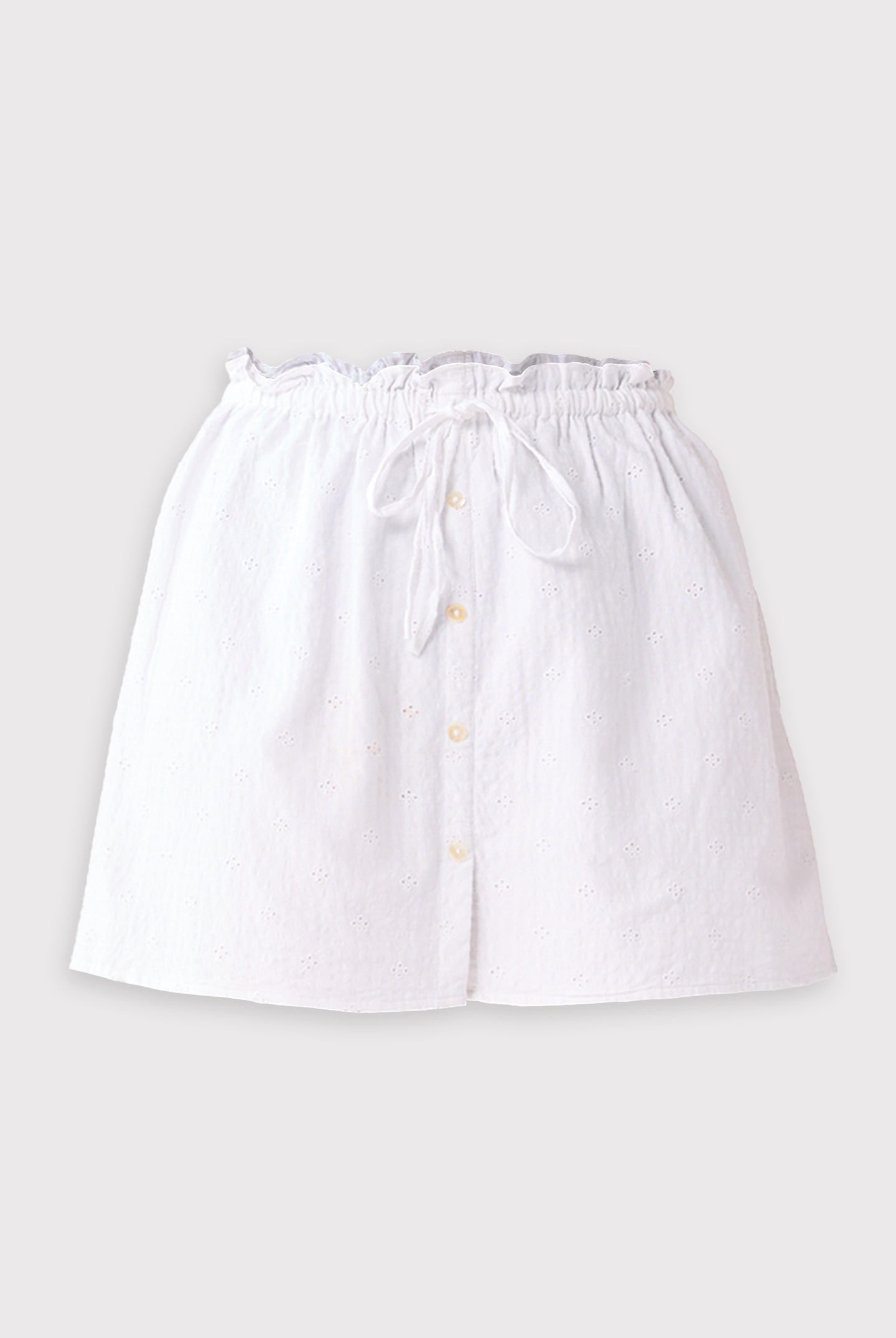 White skirt with buttons on a light gray background