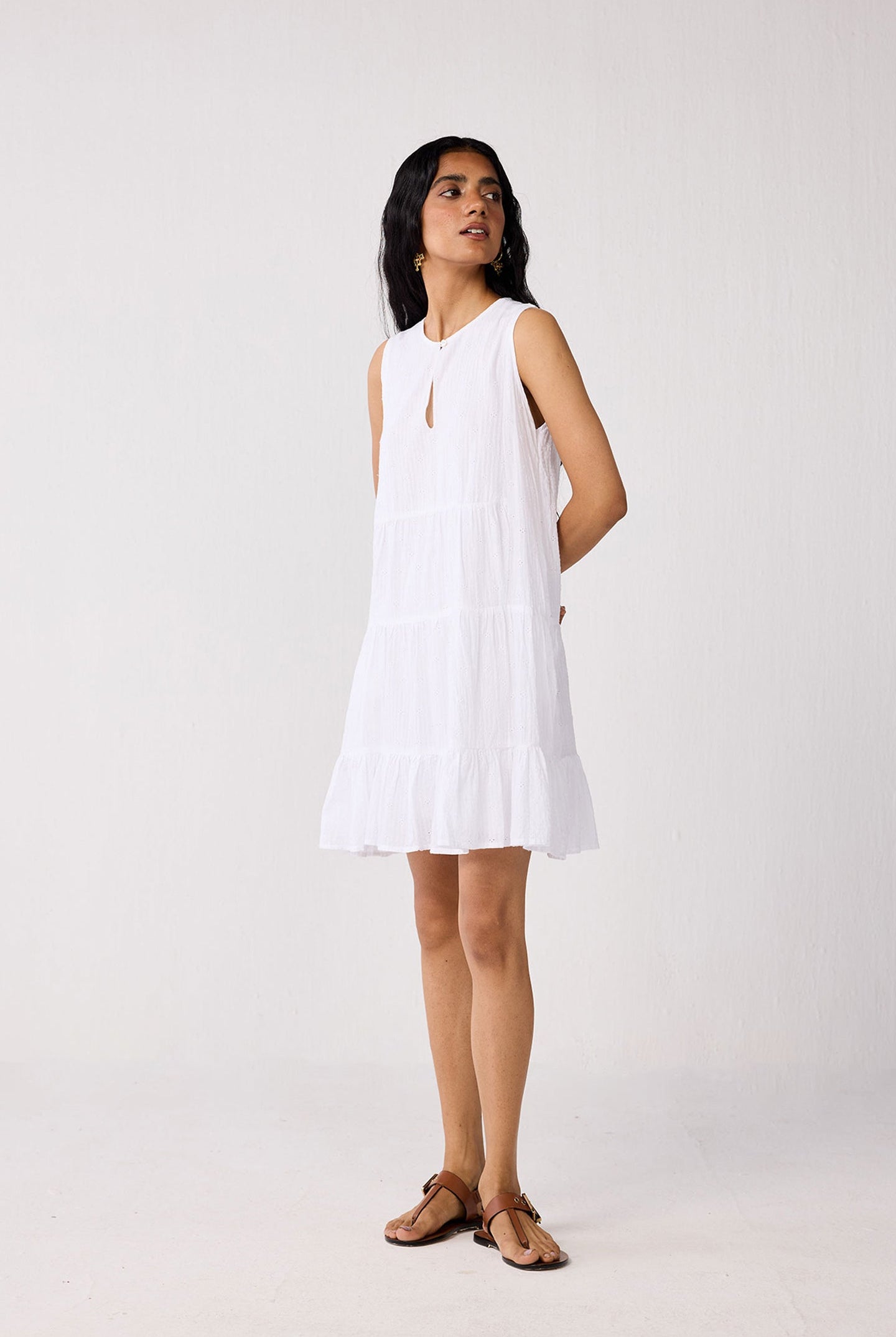Woman wearing a white dress against a plain background