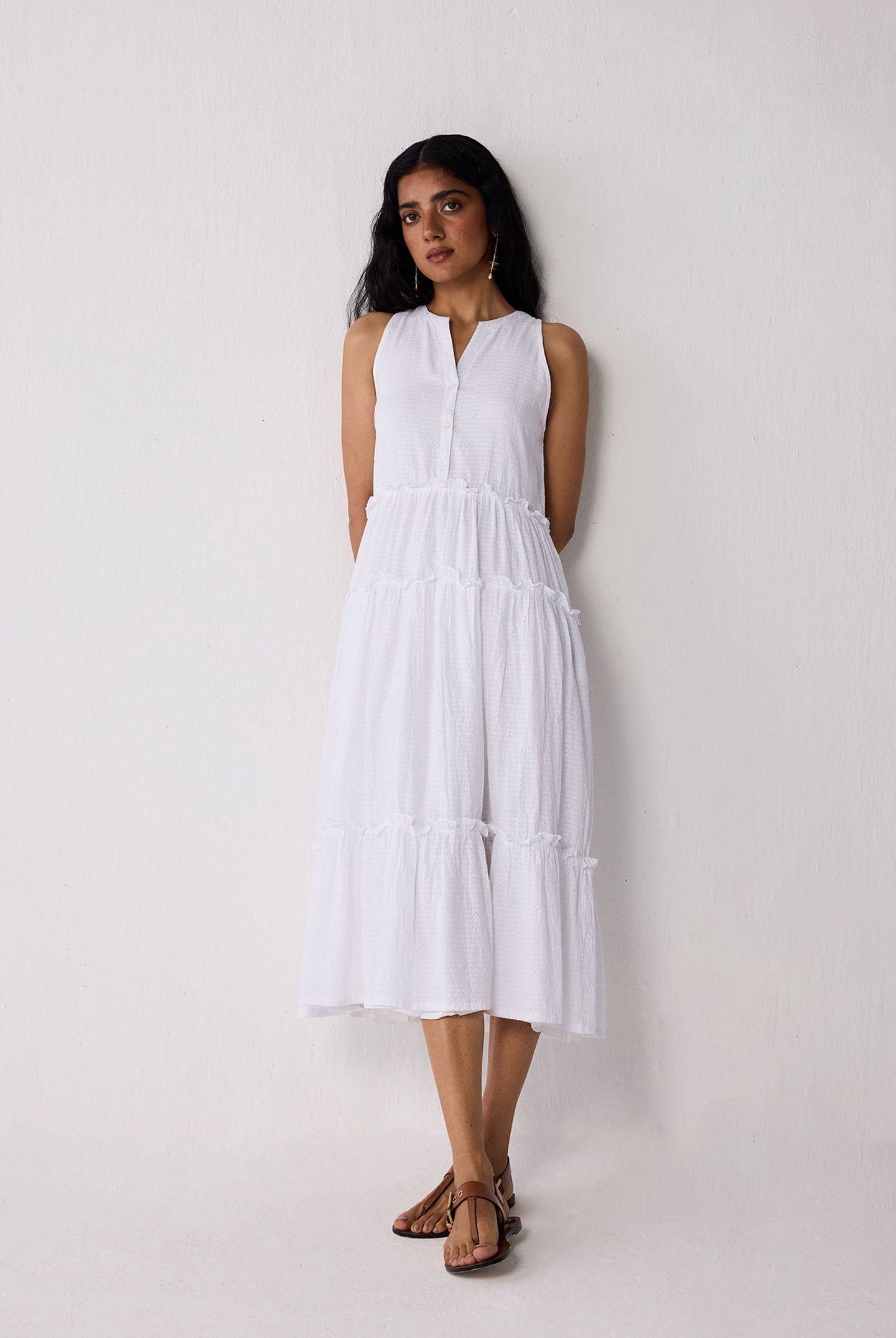 Woman wearing a white dress against a plain background