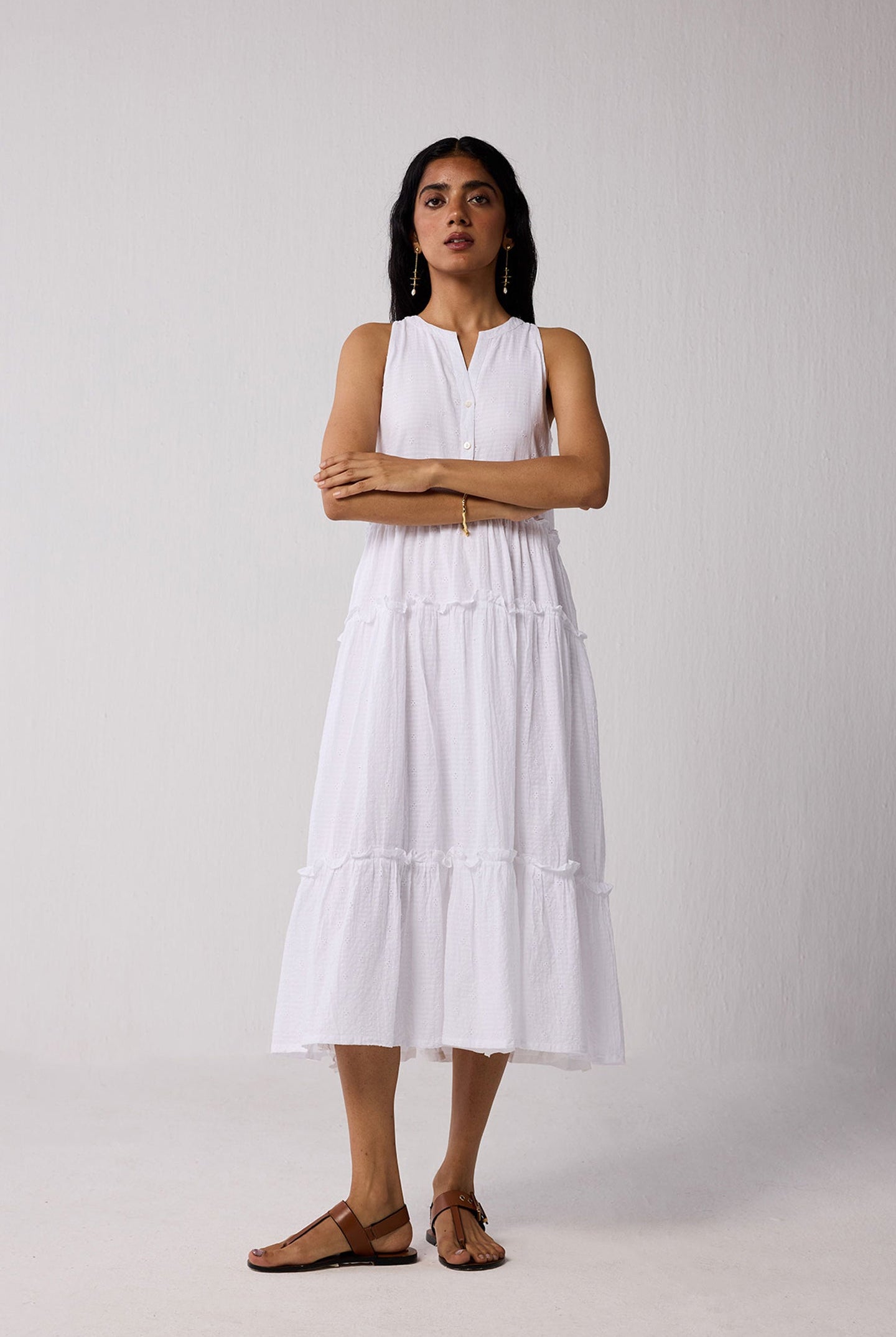 Woman wearing a white dress against a plain background