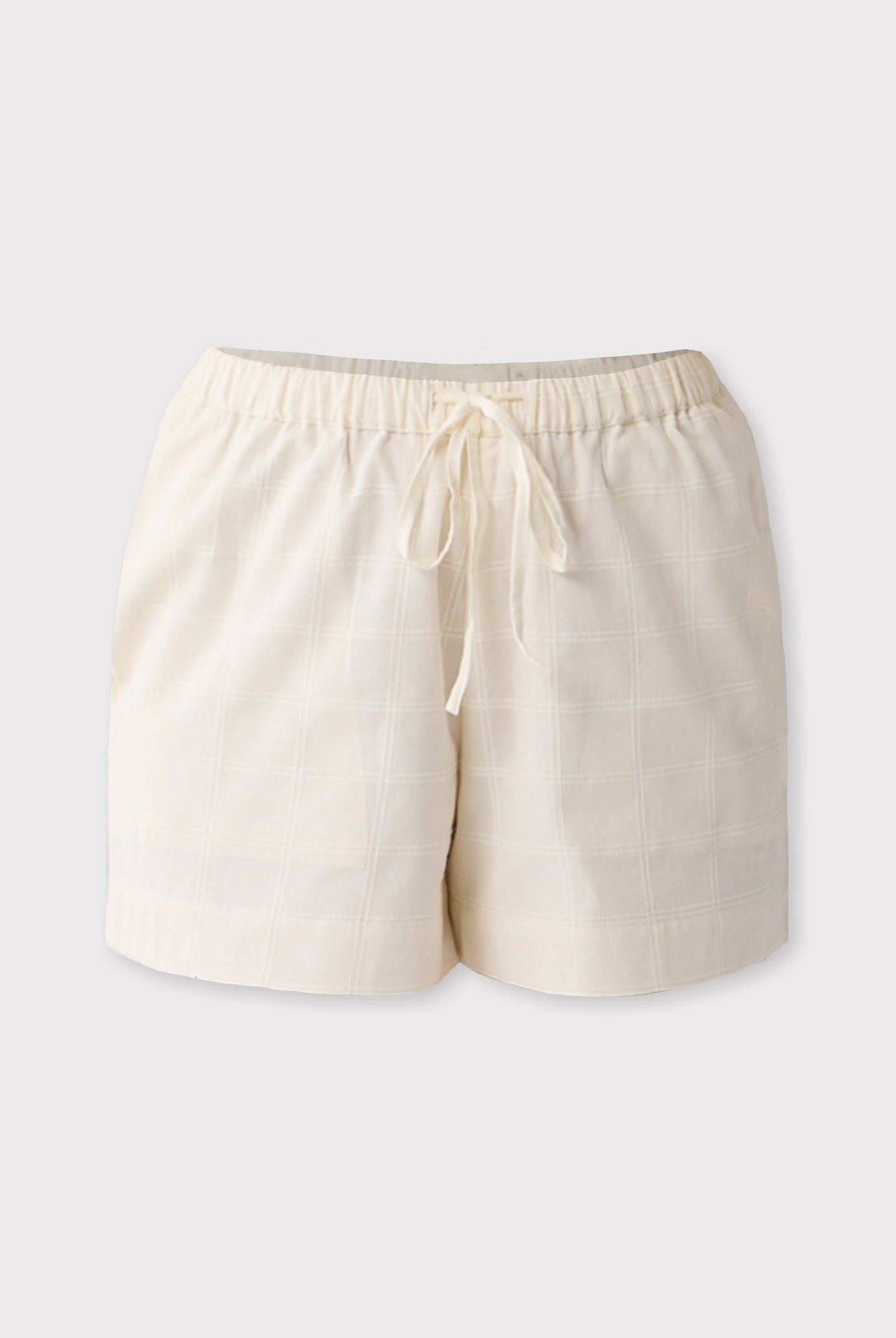 Off-white shorts with a drawstring on a light gray background