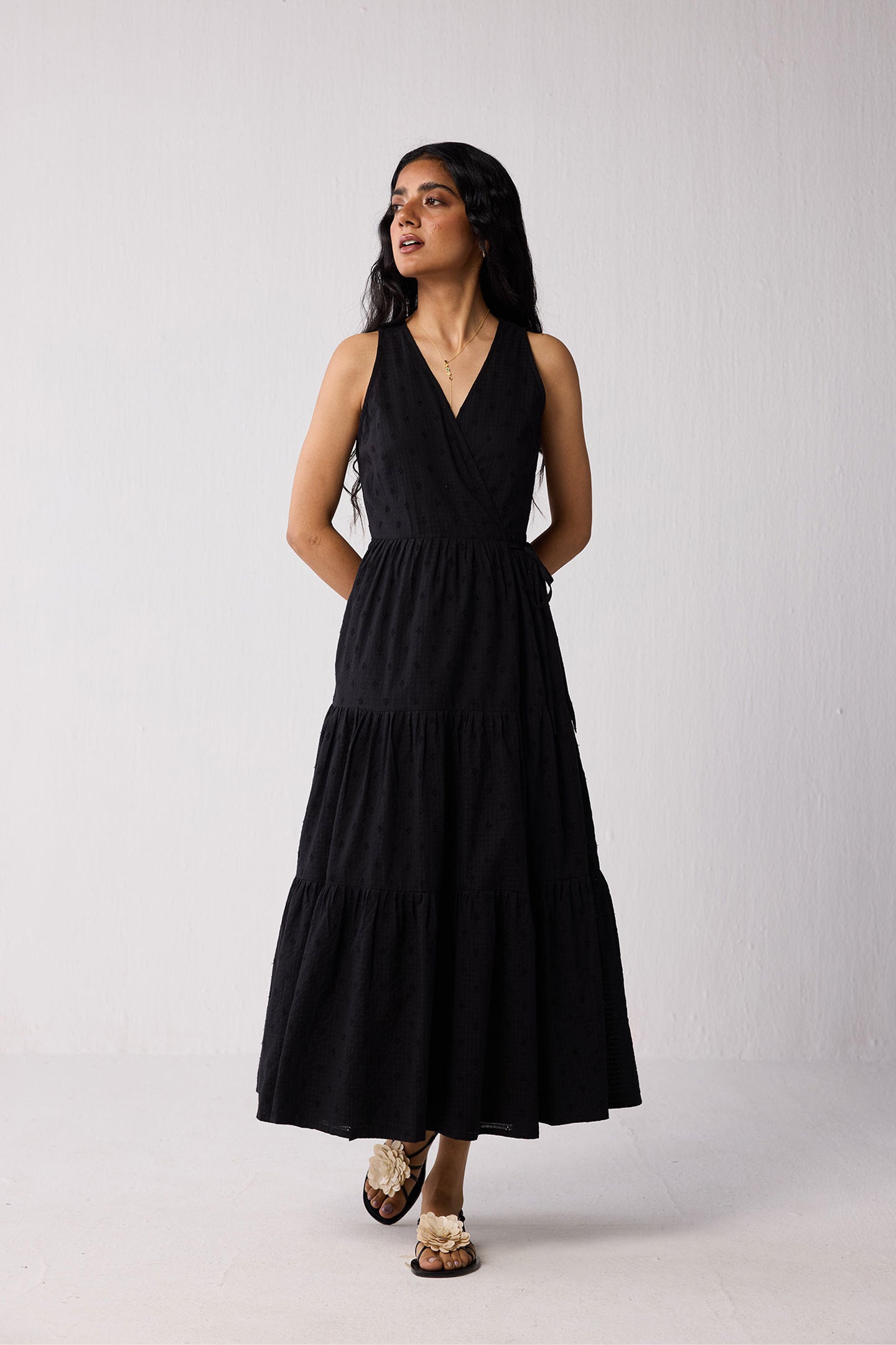 Woman wearing a black dress against a white background