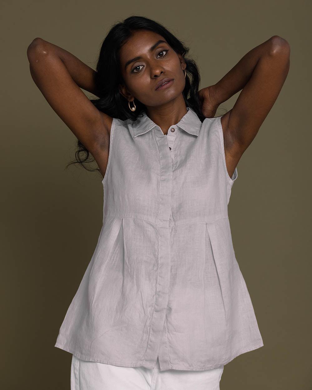 grey sleeveless collared top with a hidden placket lends a sleek look to this classic top.