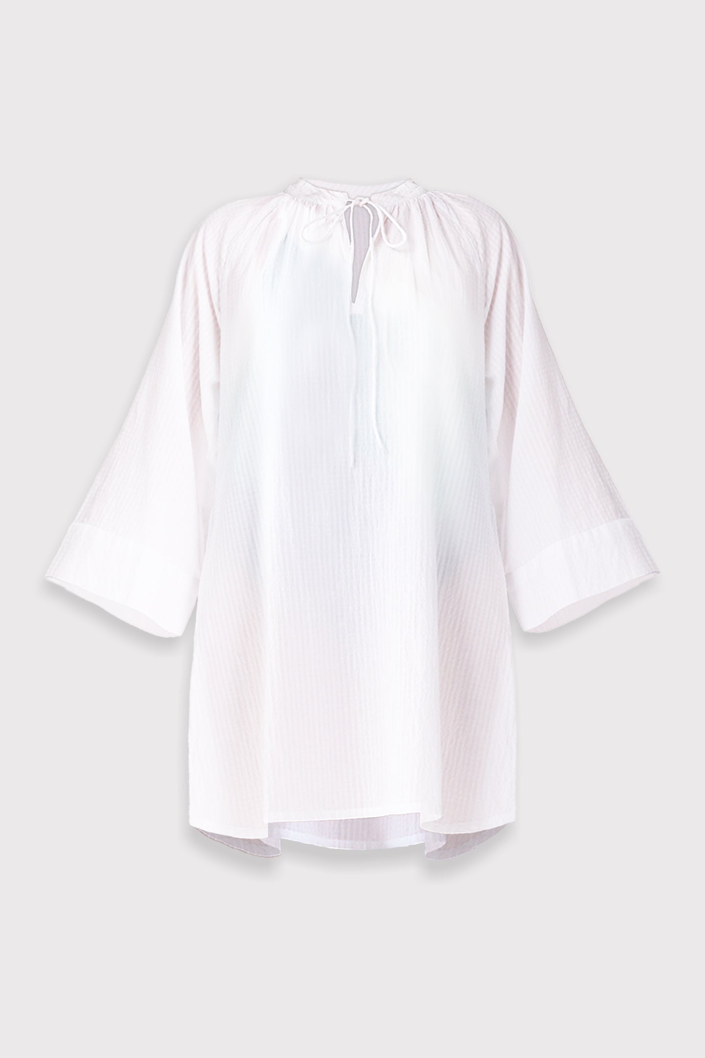 White beach cover-up with bell sleeves on a light gray background