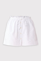 White skirt with buttons on a light gray background