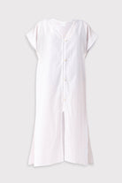 White dress with buttons on a light gray background