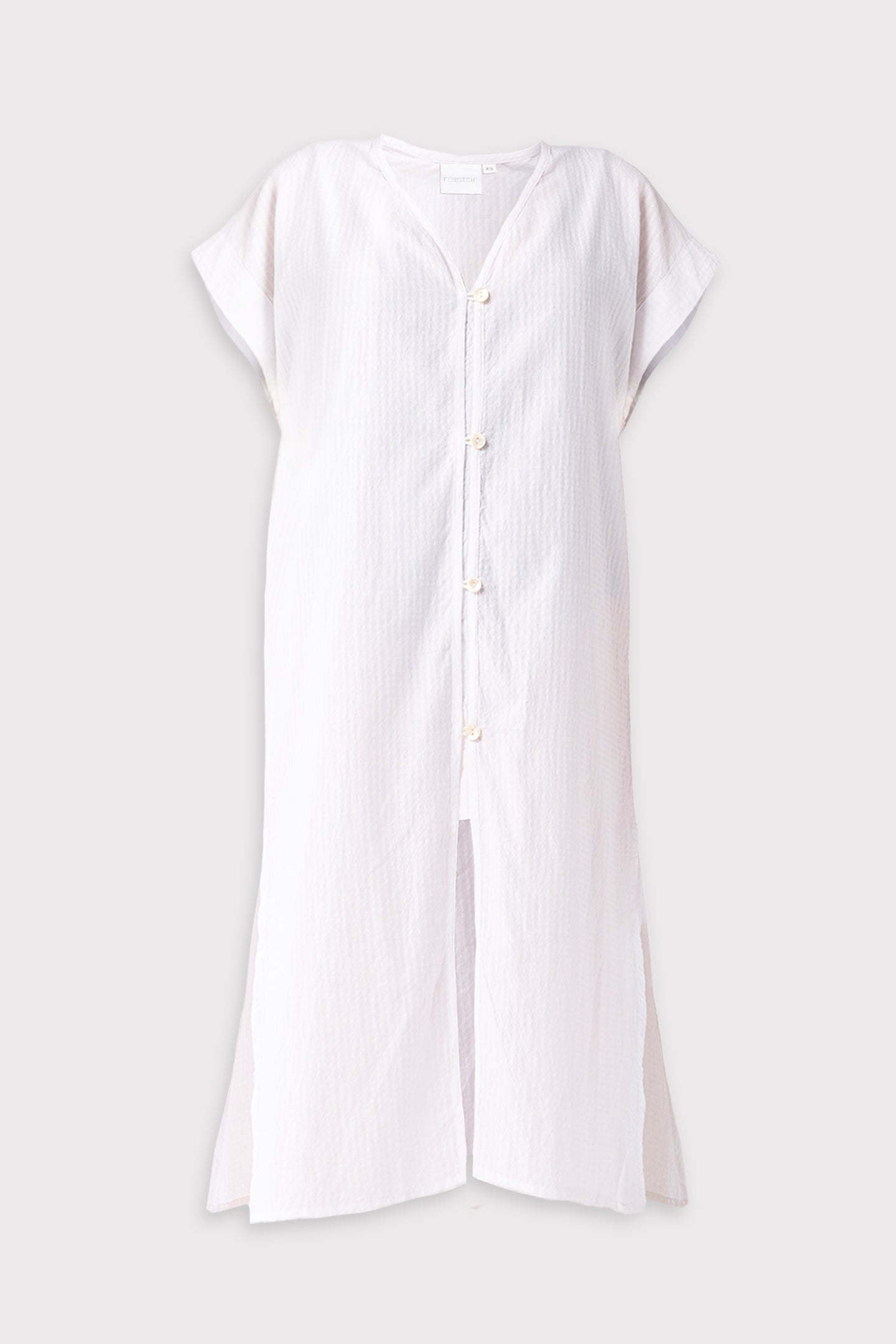 White dress with buttons on a light gray background