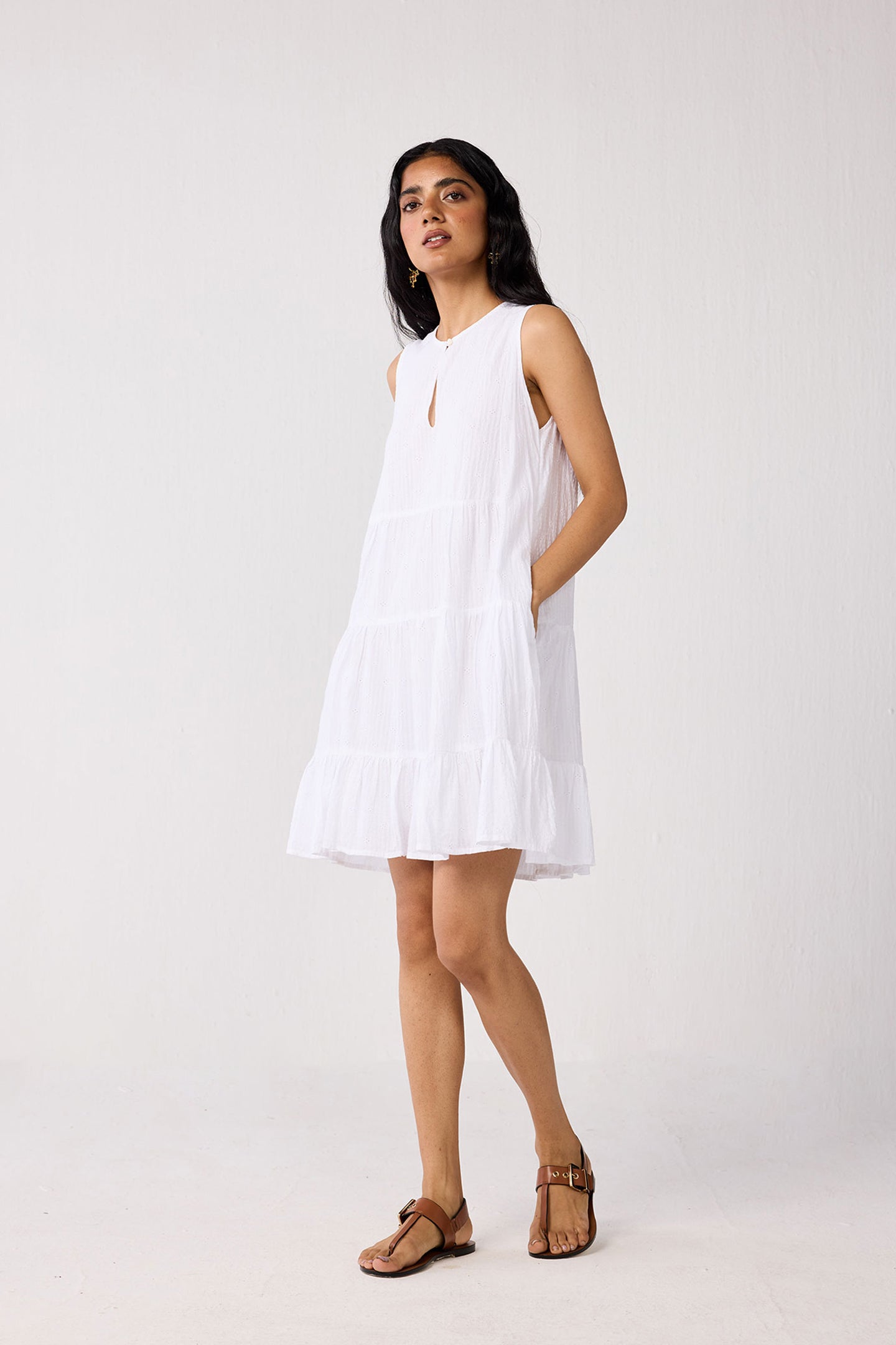 Woman wearing a white dress on a plain background