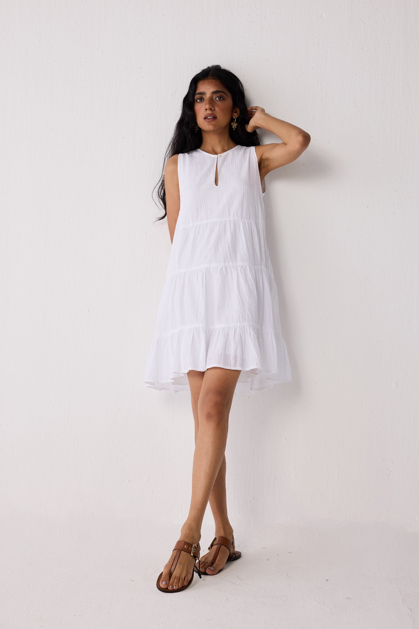 Woman wearing a white dress against a plain background