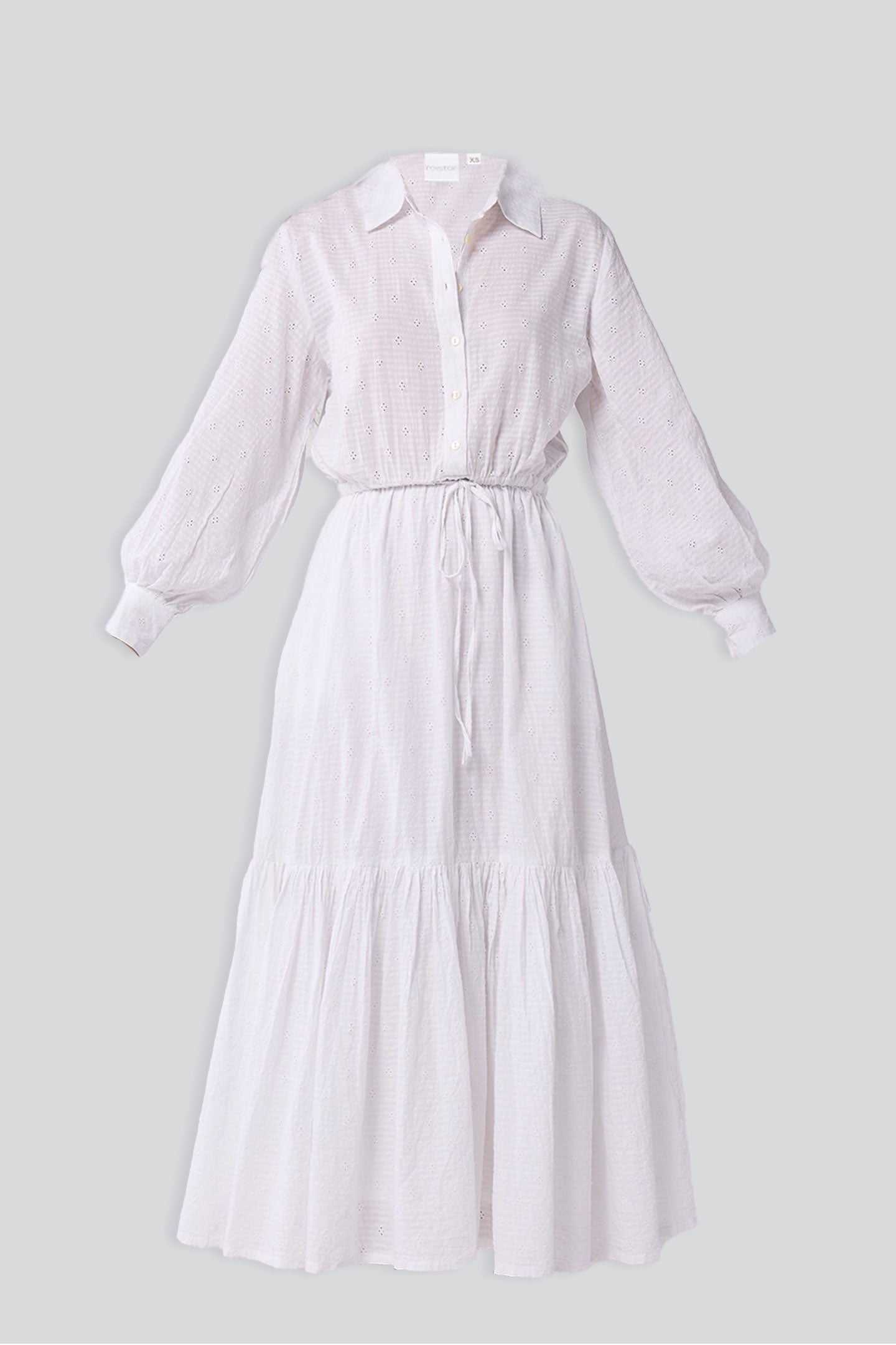 White dress with long sleeves on a light gray background