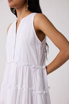 White sleeveless dress worn by a person on a plain background