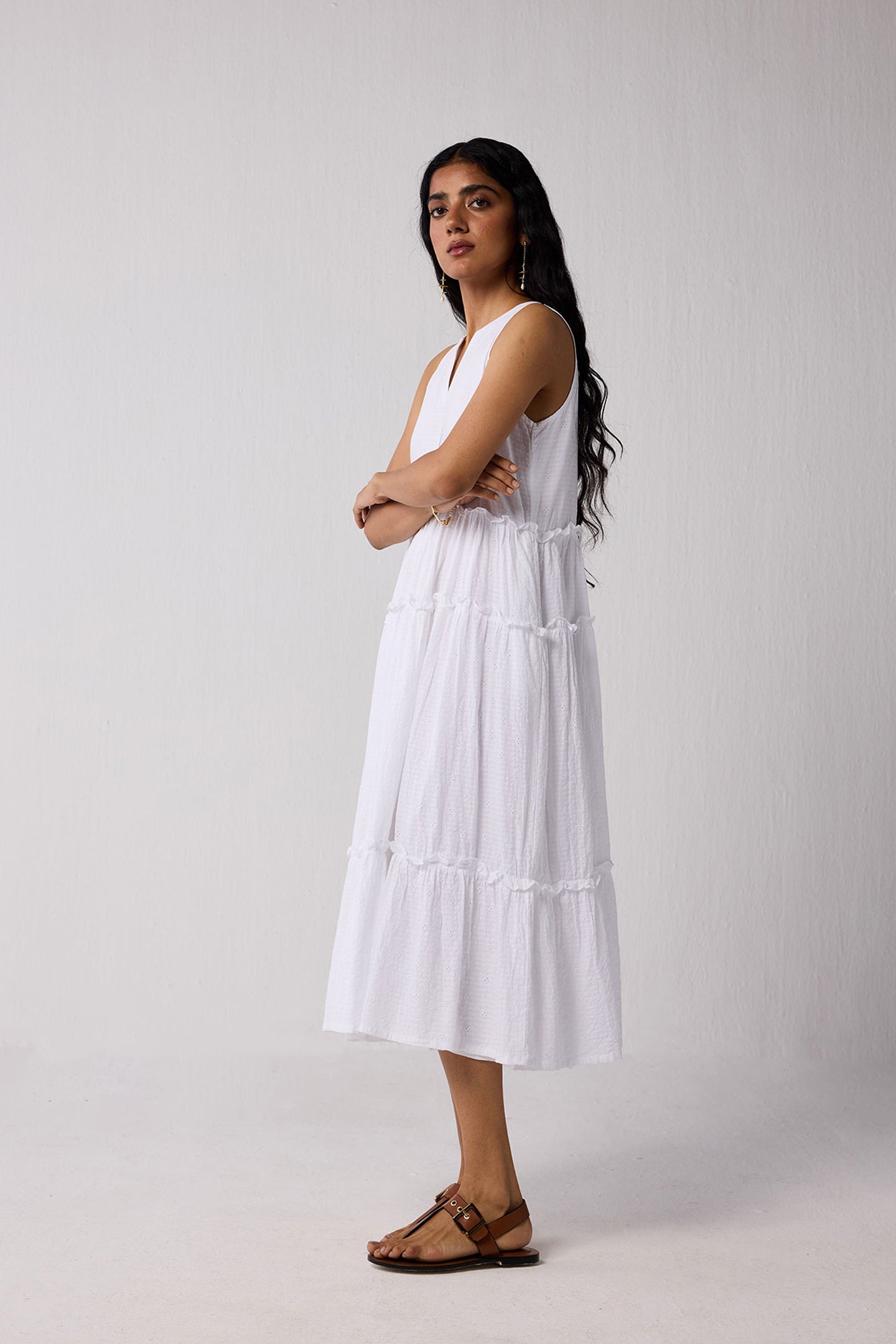 Woman wearing a white dress with a plain background