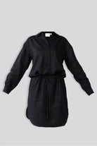 Black dress with a belt on a light gray background