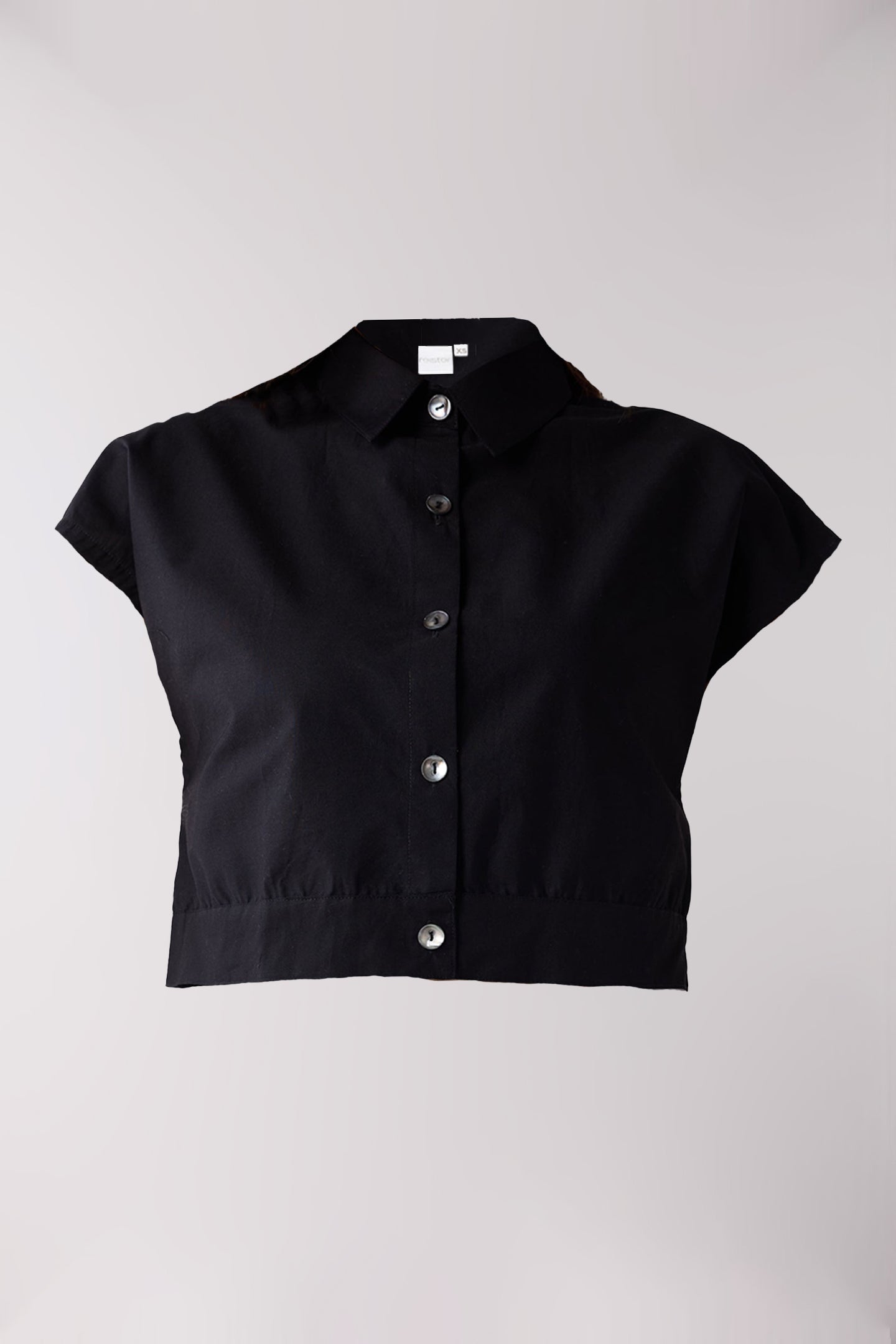Black short-sleeve blouse with buttons on a light gray background