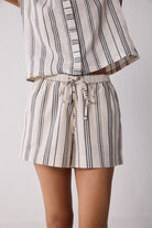 Striped outfit with a top and shorts on a plain background
