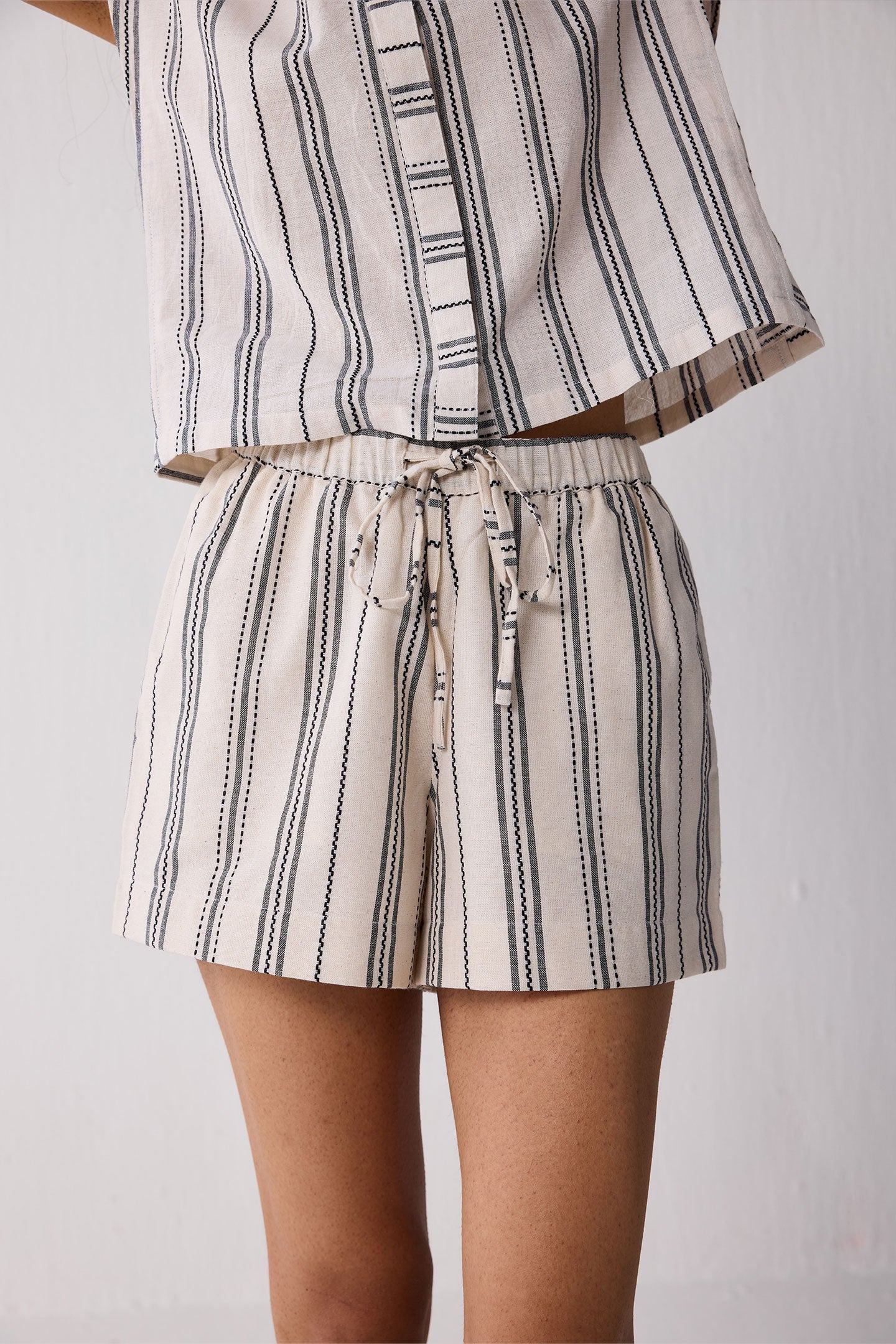 Striped outfit with a top and shorts on a plain background