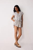 Woman wearing a striped outfit against a white background