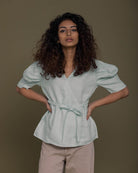 mint wrap top with a sash and puffed sleeves