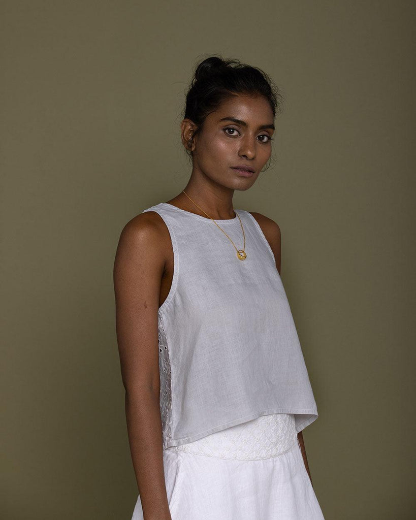 grey camisole top with embroidery on the back and brown buttoned details