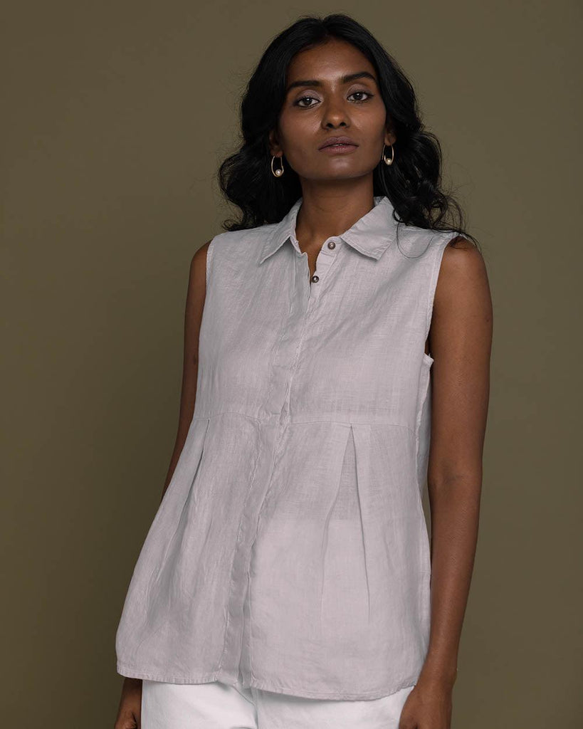 grey sleeveless collared top with a hidden placket lends a sleek look to this classic top.